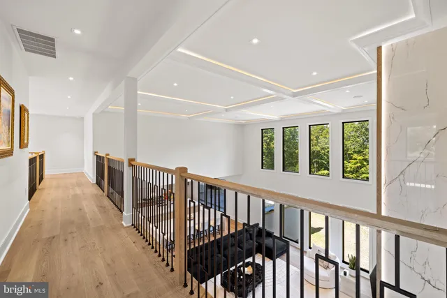 a roof deck with table and chairs and potted plants