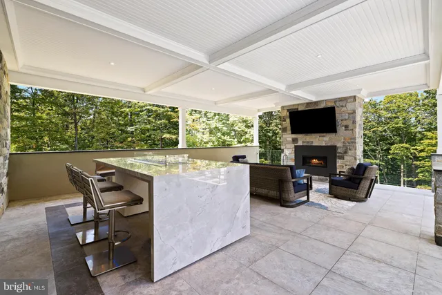 a living room with patio furniture and a flat screen tv