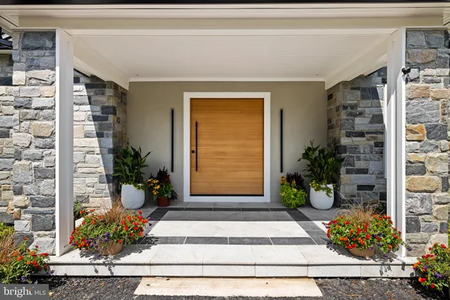 a view of a living room with a black white checkered floor with couches chair and a coffee table
