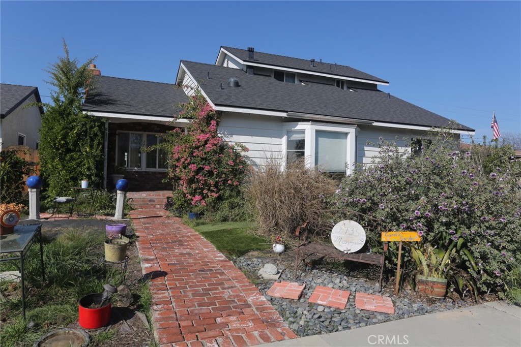 a front view of a house with a garden