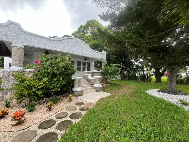 a front view of a house with garden