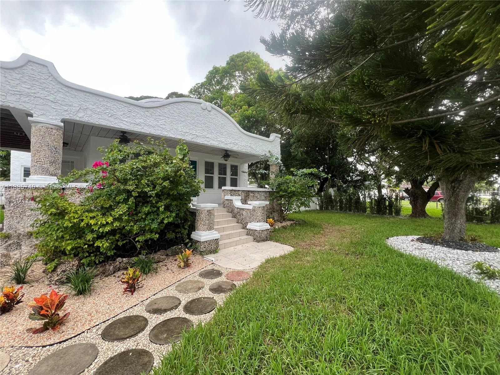 a front view of a house with garden