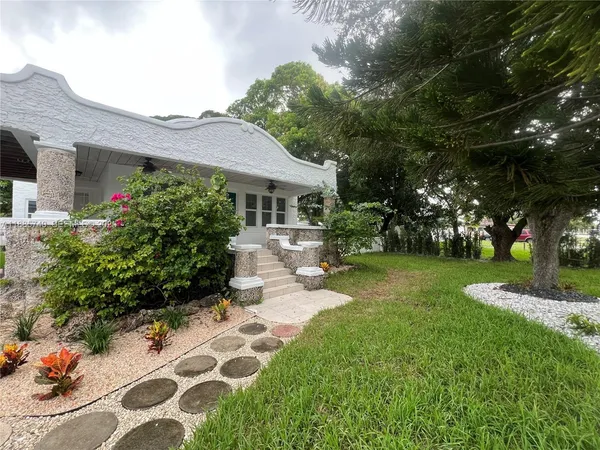 a front view of a house with garden