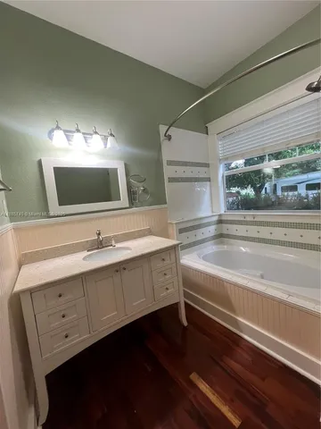 a bathroom with a sink and a large mirror
