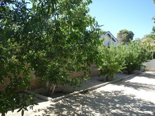723 West Kevin Court Ridgecrest, CA 93555 - Photo 41 of 48 a backyard of a house with a yard and outdoor seating