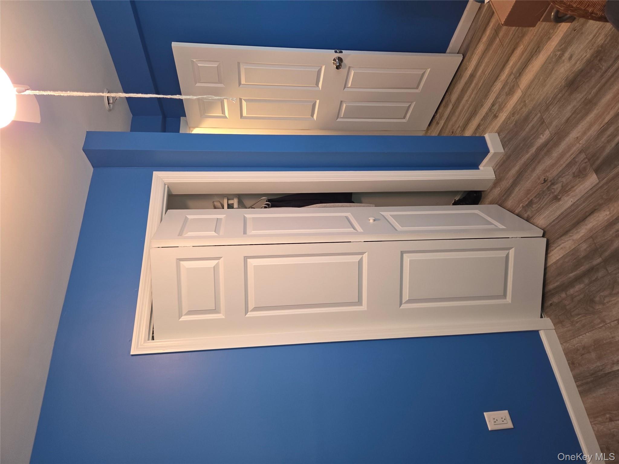 3095 Mullan Place Bronx, NY 10465 - Photo 11 of 12 Unfurnished bedroom with dark wood-style floors and a closet