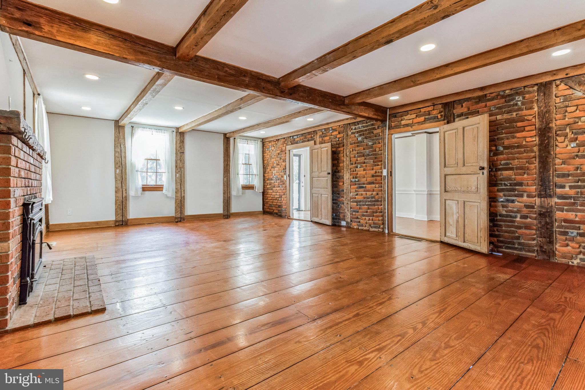 107 Millstone Road Millstone Township, NJ 08535 - Photo 11 of 28 Living room with brick wall and original beams