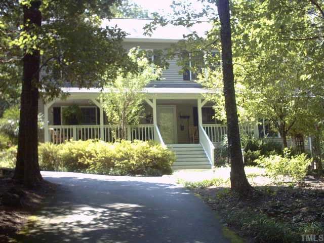 1287 Chub Lake Road Roxboro, NC 27574 - Photo 1 of 10 a front view of a house with garden