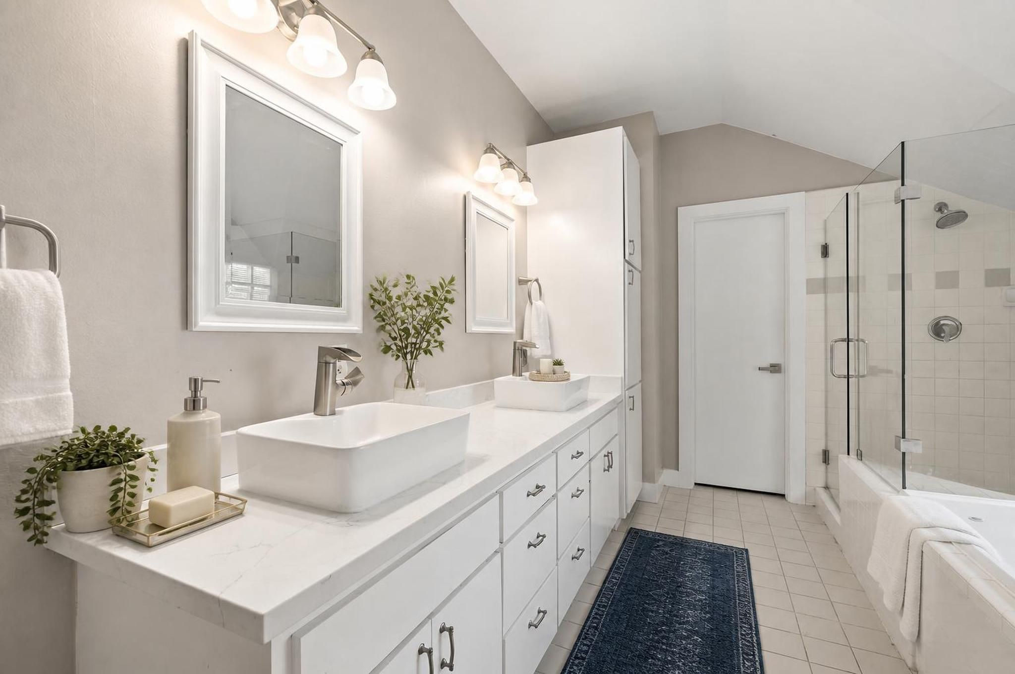 2154 Arabelle Street Houston, TX 77007 - Photo 5 of 45 The primary bathroom feels spacious and complete with double sinks, a jetted tub, and a separate shower. It brings comfort and function together in a clean ensuite setting. Virtually staged.