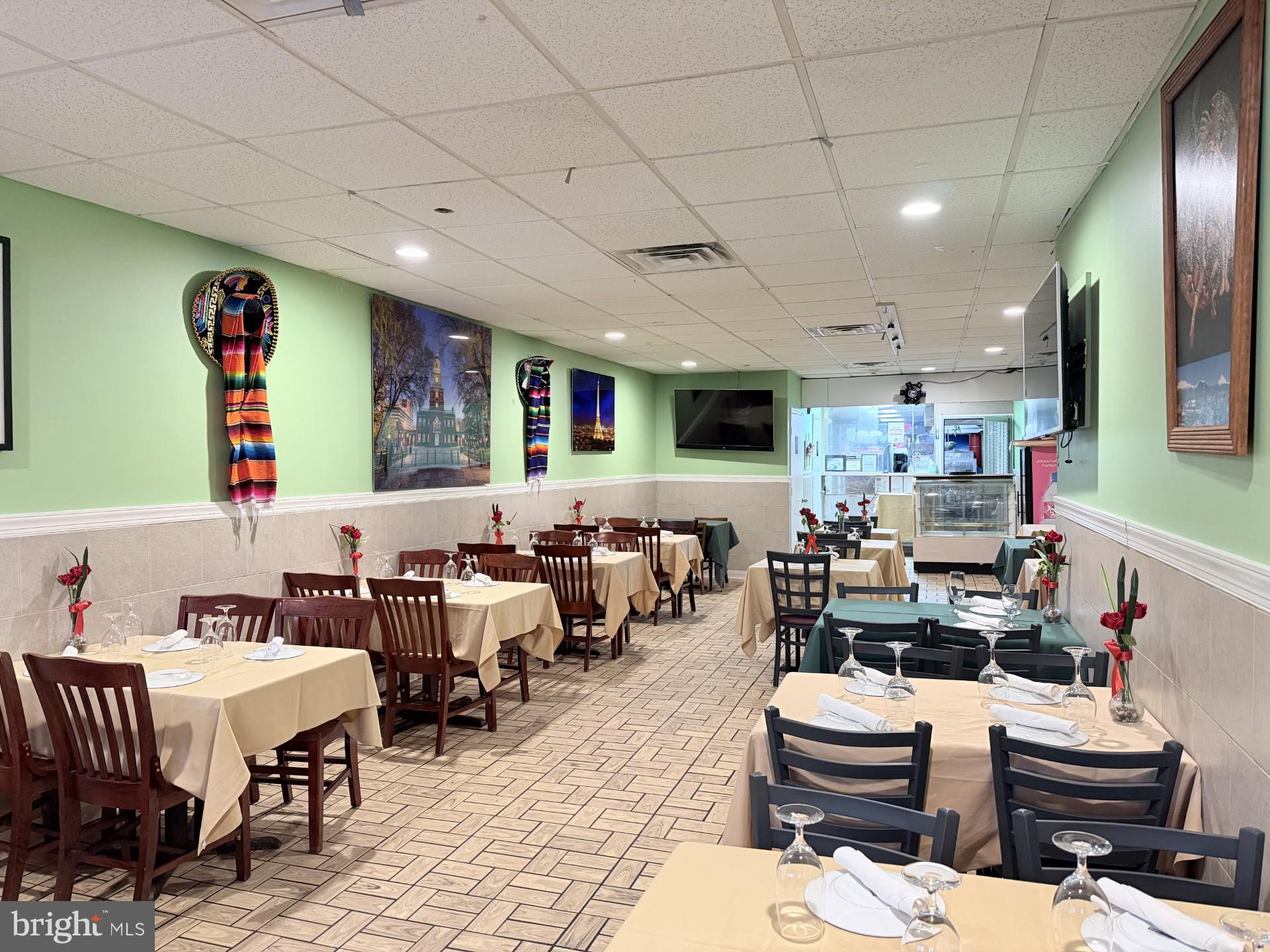 a living room with lots of furniture and kitchen view