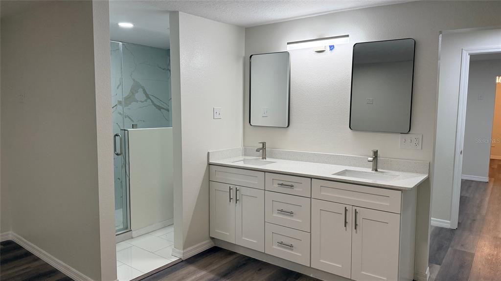 15535 Little Ranch Road Spring Hill, FL 34610 - Photo 16 of 46 a bathroom with a double vanity sink and mirror