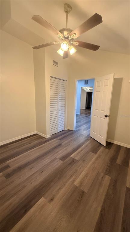 15535 Little Ranch Road Spring Hill, FL 34610 - Photo 22 of 46 an empty room with wooden floor and windows