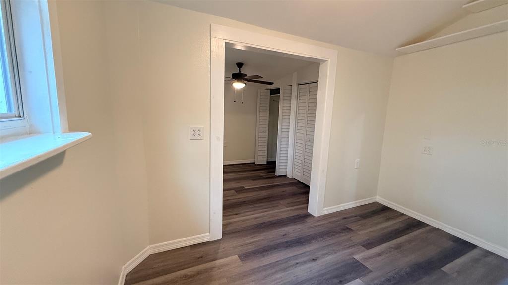 15535 Little Ranch Road Spring Hill, FL 34610 - Photo 25 of 46 a view of a hallway with wooden floor
