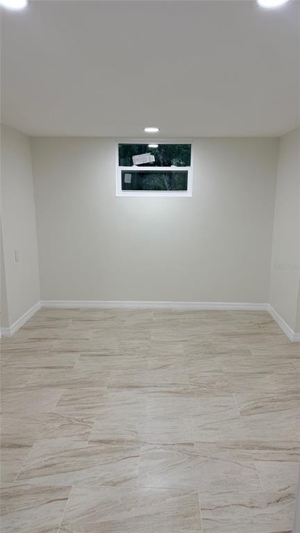 15535 Little Ranch Road Spring Hill, FL 34610 - Photo 31 of 46 a view of a room with wooden floor and white walls