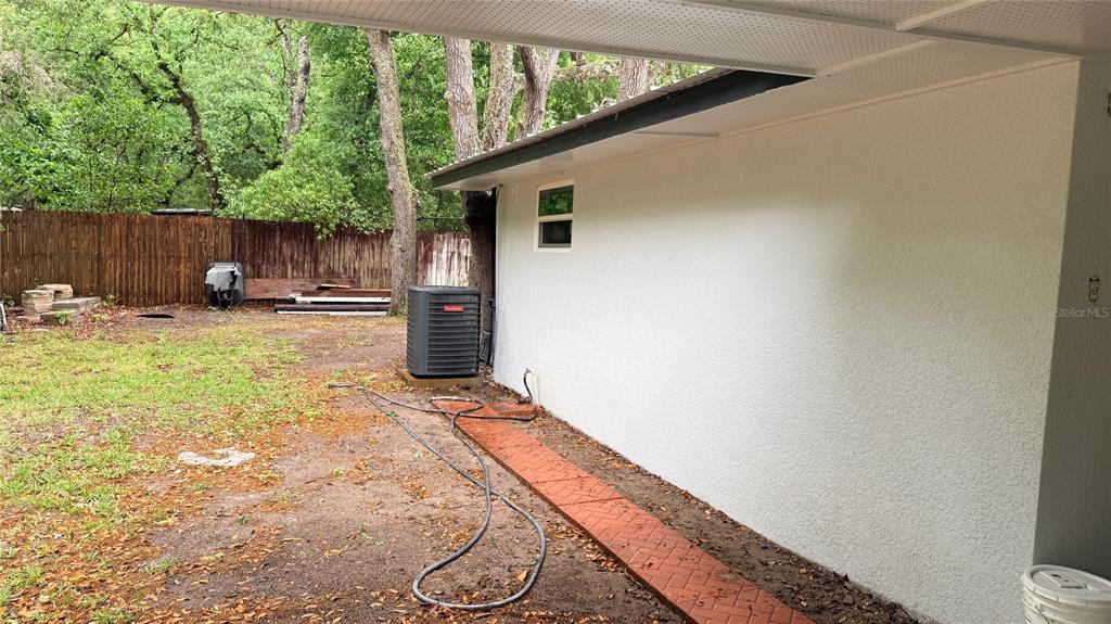 15535 Little Ranch Road Spring Hill, FL 34610 - Photo 36 of 46 a view of a backyard with chair and wooden fence