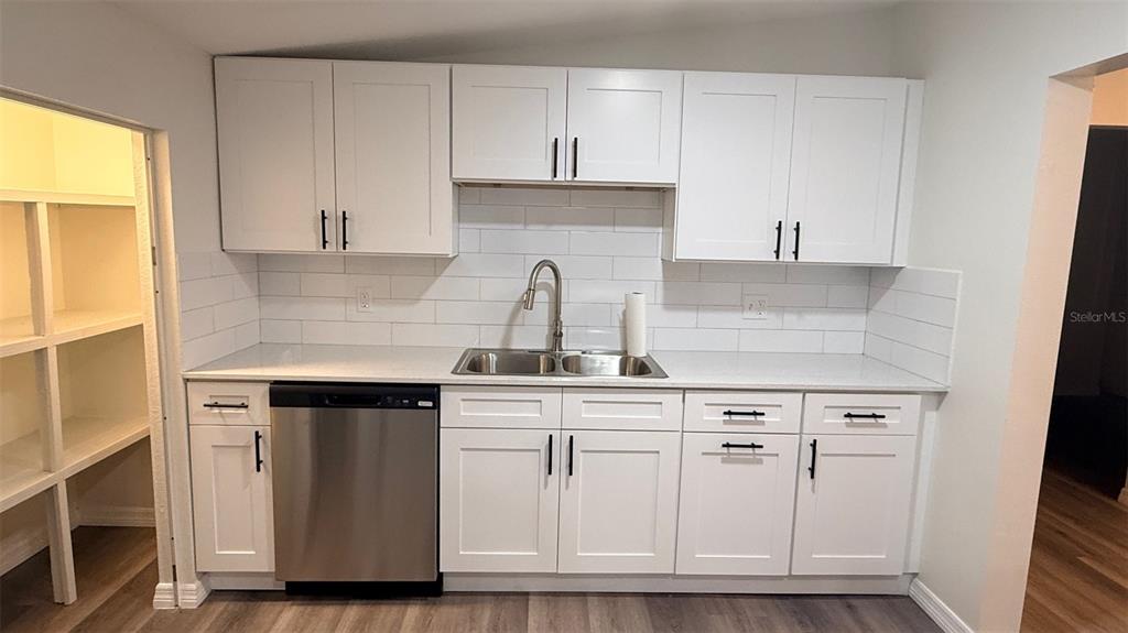 15535 Little Ranch Road Spring Hill, FL 34610 - Photo 6 of 46 a kitchen with white cabinets and sink