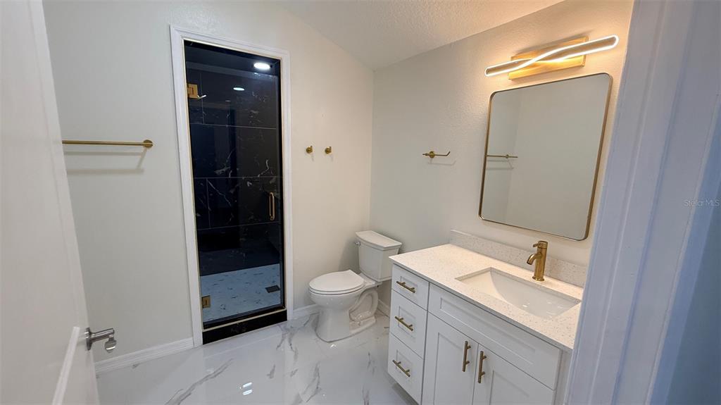 15535 Little Ranch Road Spring Hill, FL 34610 - Photo 8 of 46 a bathroom with a sink toilet and shower