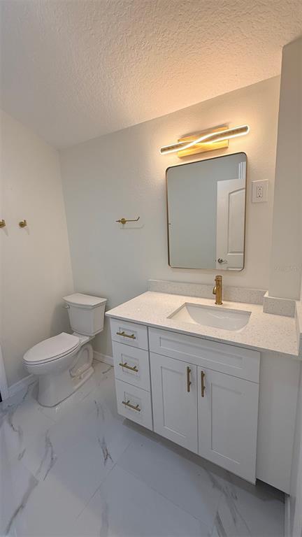 15535 Little Ranch Road Spring Hill, FL 34610 - Photo 9 of 46 a bathroom with a toilet sink and mirror