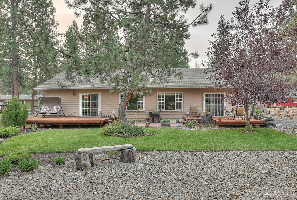 60031 Hopi Road Bend, OR 97702 - Photo 13 of 20 a front view of a house with a garden and trees