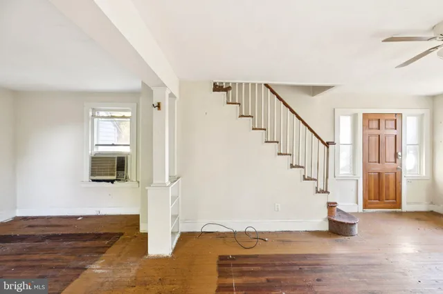 a view of entryway and hall with wooden floor