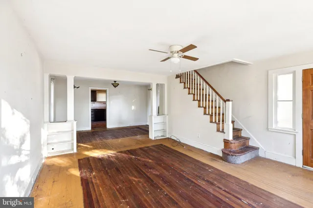 a view of an empty room and wooden floor