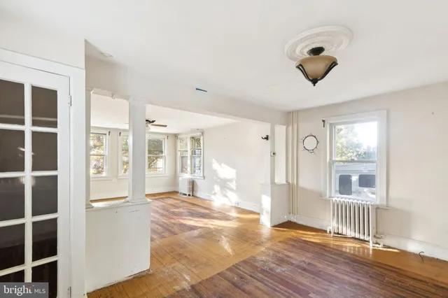 a view of a room with wooden floor and windows