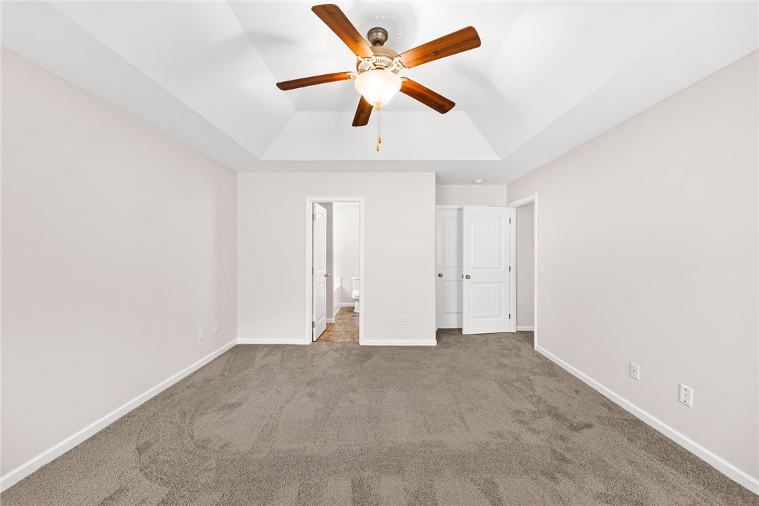 113 Crofton Court Easley, SC 29642 - Photo 23 of 33 This spacious bedroom features a vaulted ceiling and soft carpet, ready for your personal touch.