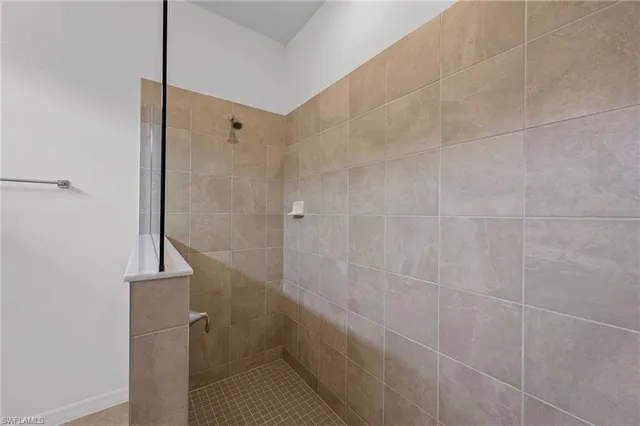 a bathroom with a granite countertop sink mirror and shower
