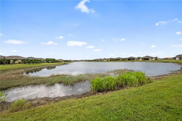 a view of a lake with houses in the back