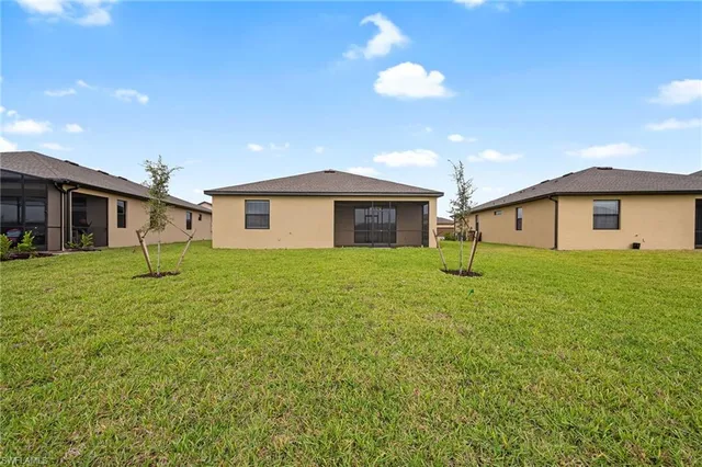 a front view of house with yard and green space