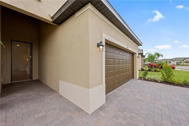 a view of an entrance to house with yard and road