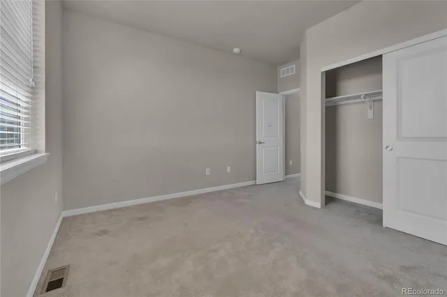 an empty room with closet area