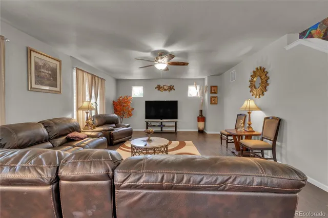 a living room with furniture chandelier and a fireplace