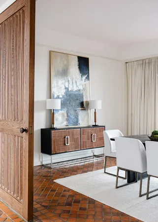 a spacious bedroom with a bed and a dresser in it