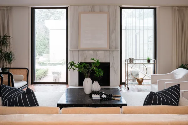 a living room with furniture and floor to ceiling window