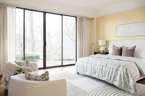 a spacious bedroom with a large bed and a large window