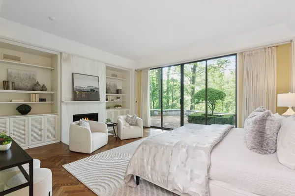 a bedroom with furniture and a large window