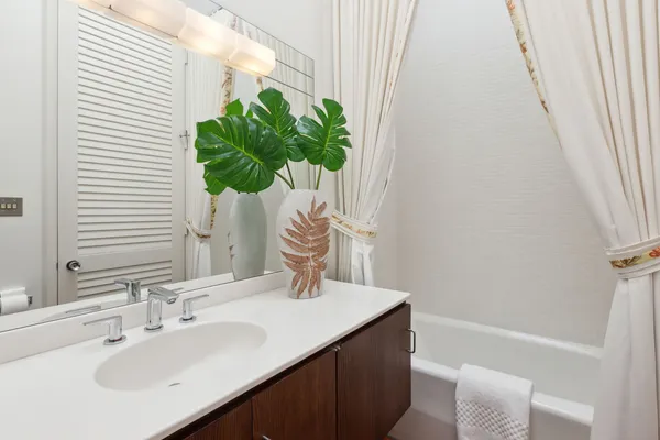 a bathroom with a sink a vanity and a mirror