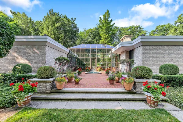 a view of a house with a patio and a garden