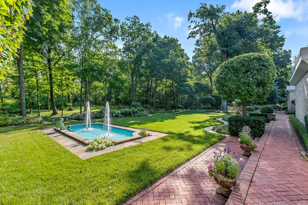 a view of a backyard with swimming pool