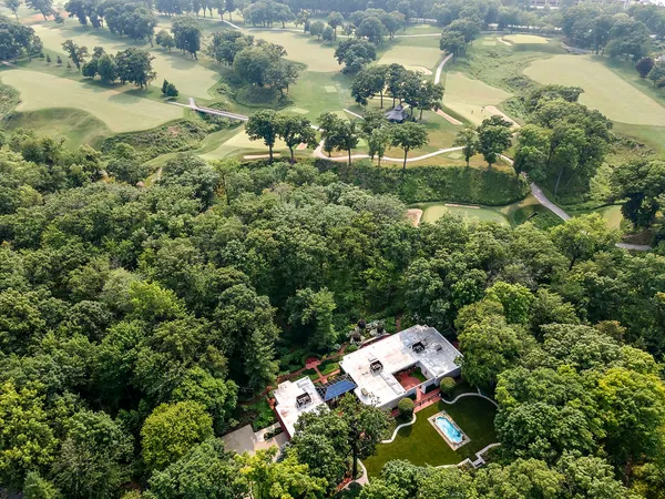 an aerial view of a house with a yard and lake view