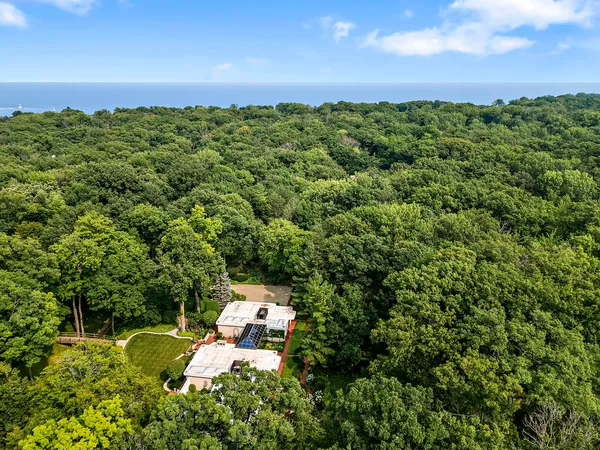 an aerial view of a house with a yard