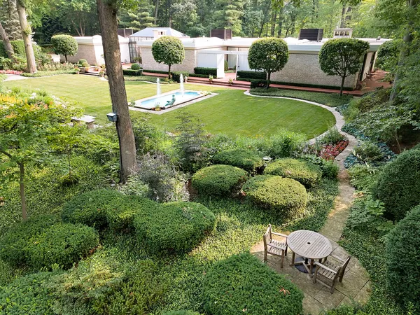 an aerial view of a house with swimming pool garden and patio