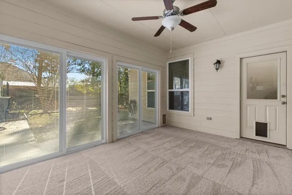 a view of an empty room with glass door