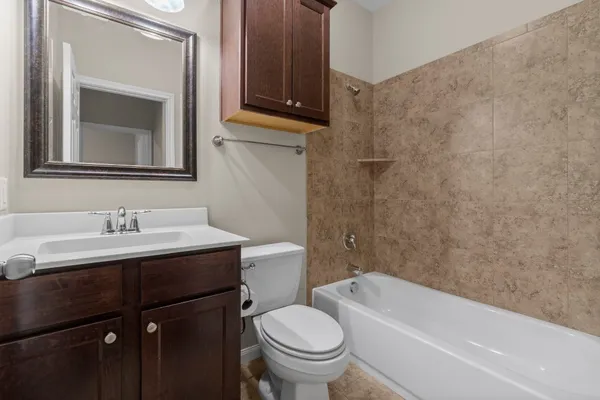 a bathroom with a toilet a sink and bathtub