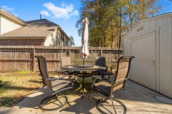 a view of a balcony with chairs and table