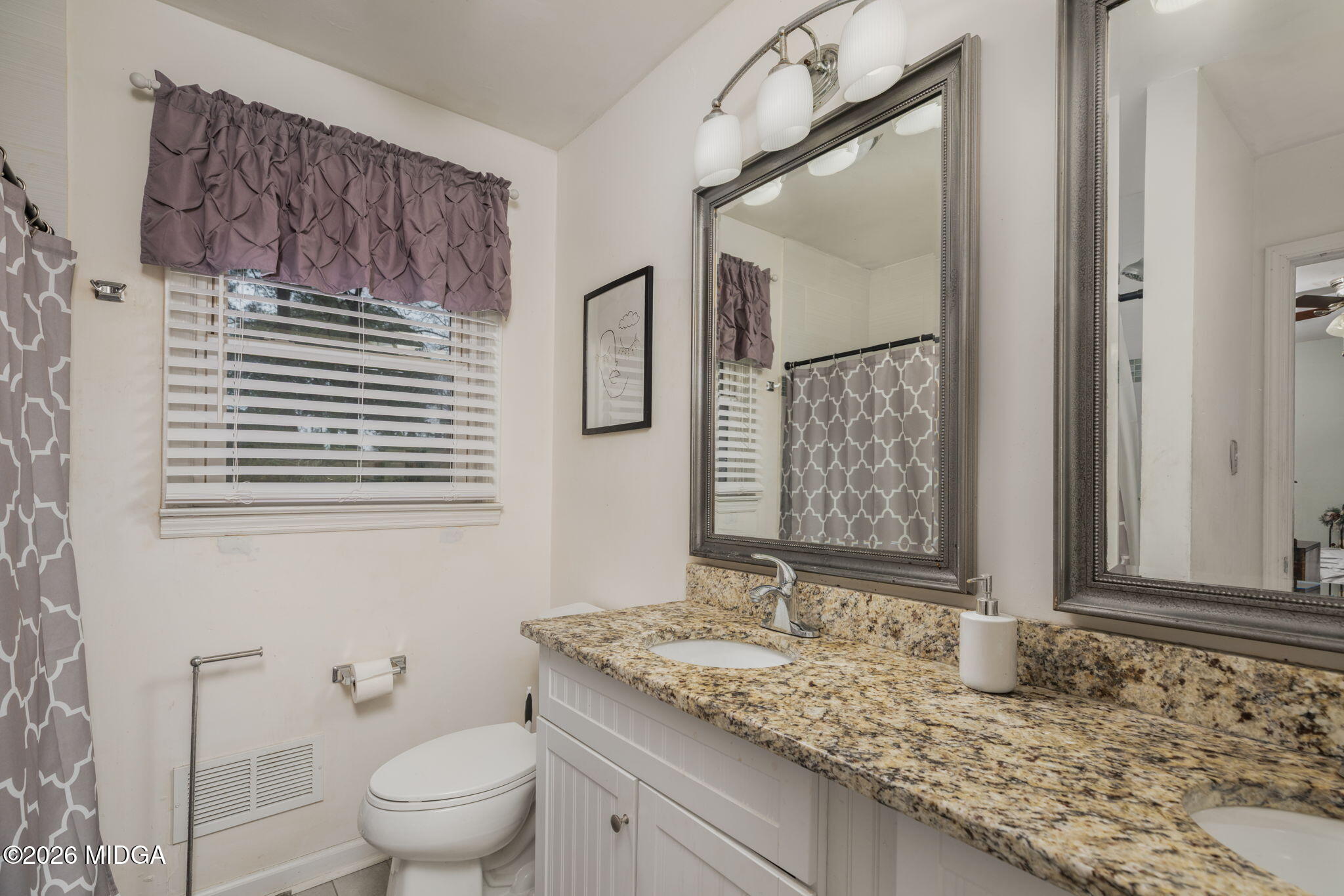 1422 Forest Hill Road Macon, GA 31210 - Photo 17 of 28 a bathroom with a granite countertop sink toilet and mirror
