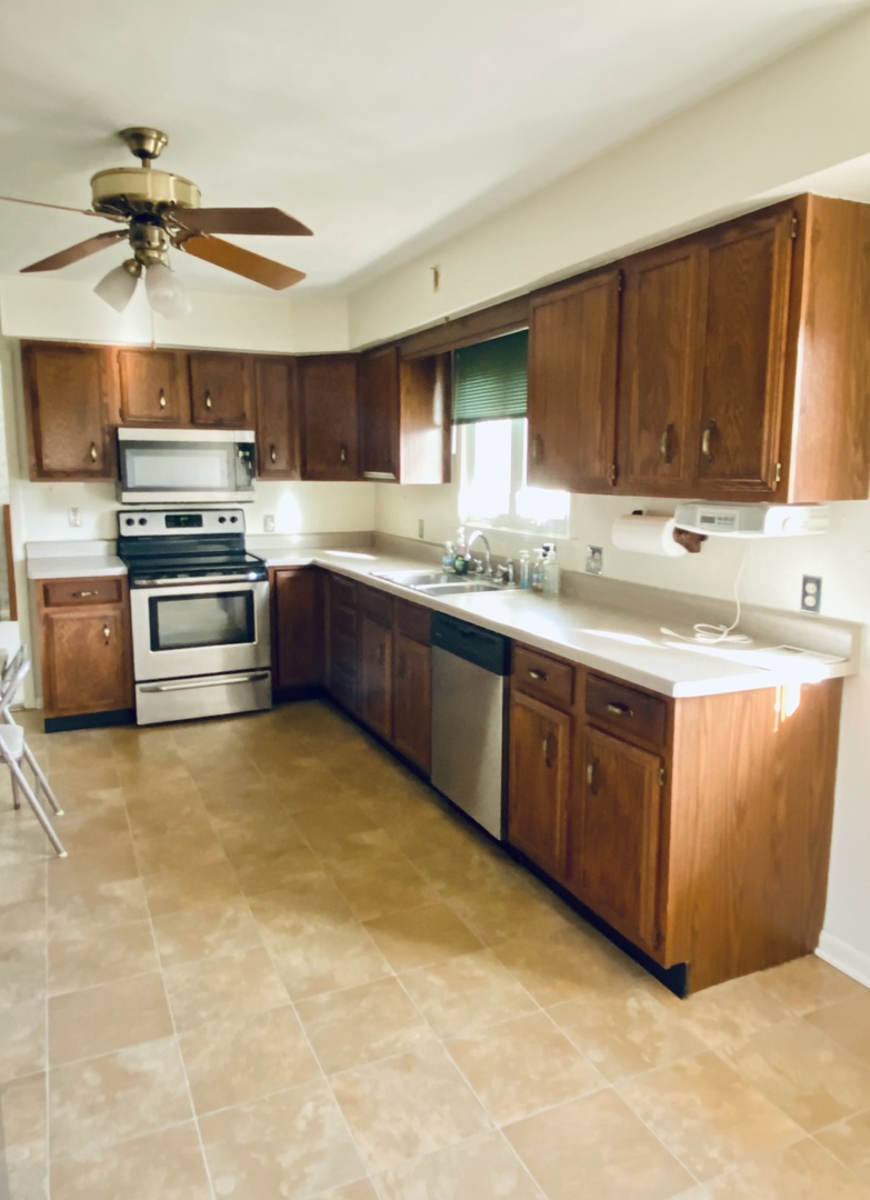 201 Janet Avenue Rochelle, IL 61068 - Photo 5 of 9 a kitchen with stainless steel appliances granite countertop a sink cabinets and wooden floor