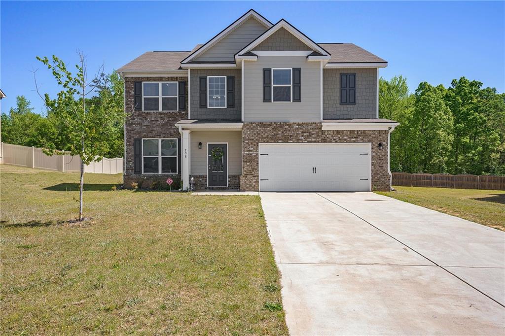208 Sophie Circle Locust Grove, GA 30248 - Photo 1 of 1 a front view of a house with a garden