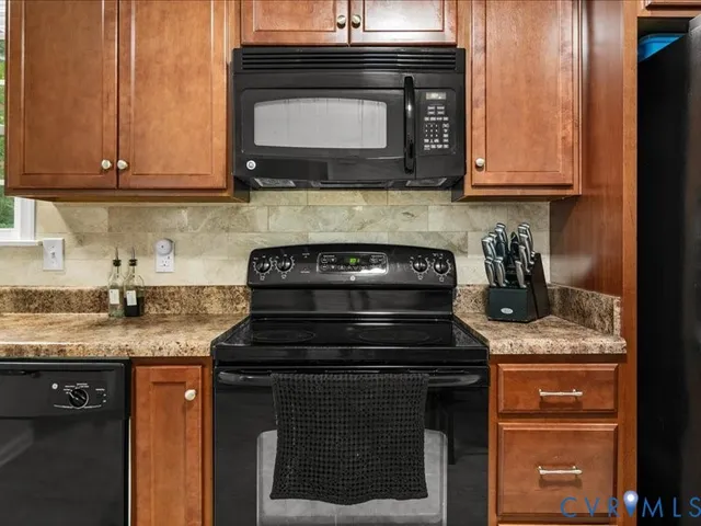 a kitchen with stainless steel appliances granite countertop a stove and a microwave